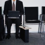 Businessman Using Laptop in Waiting Room